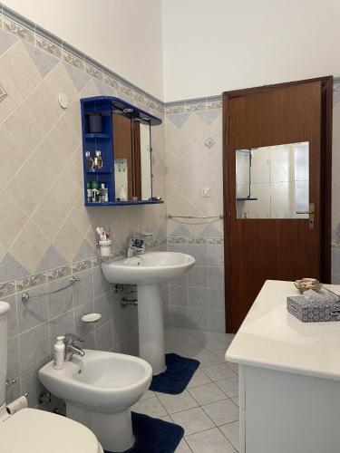 a bathroom with a sink and a toilet and a sink at Nuova Netum apartment in Noto