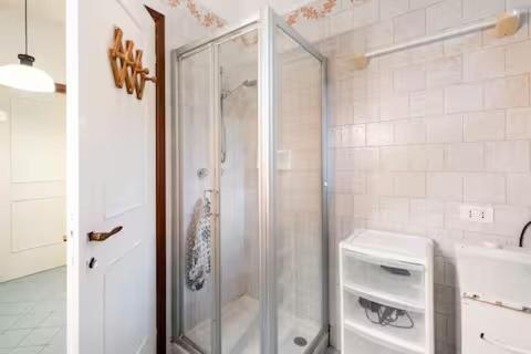 a shower with a glass door in a bathroom at Baia dei Colori in Cure