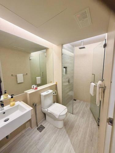 a bathroom with a toilet and a sink and a shower at Windmill Upon Hills Genting Highland by El Naura in Genting Highlands