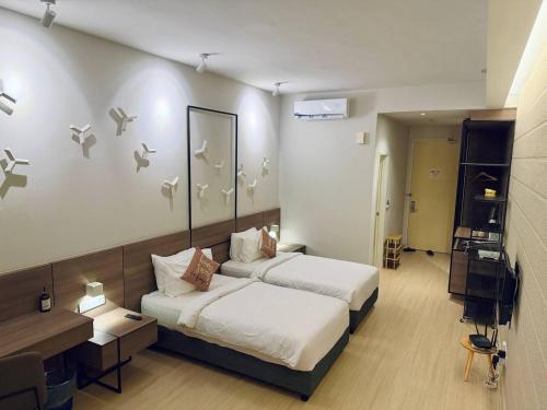 a hotel room with two beds and a television at Windmill Upon Hills Genting Highland by El Naura in Genting Highlands