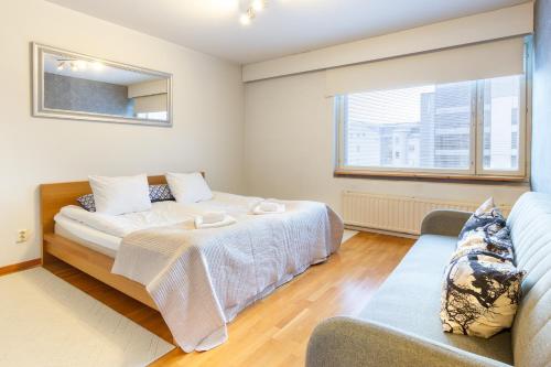 a bedroom with a bed and a couch at Aurora Family Suite in Rovaniemi