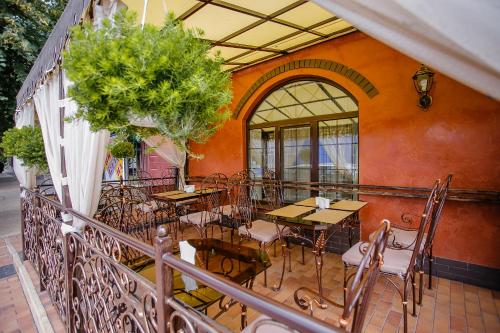 a balcony with tables and chairs on a patio at Aristokrat in Vinnytsya