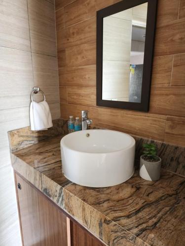 a bathroom with a white sink and a mirror at Apartment with a lagoon view in Cancún