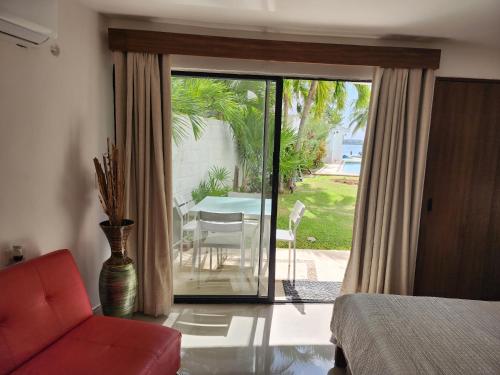 a bedroom with a sliding glass door to a patio at Apartment with a lagoon view in Cancún