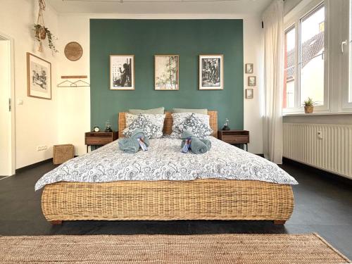 a bedroom with a large bed and a green wall at COZEE - The Oasis in Kaiserslautern