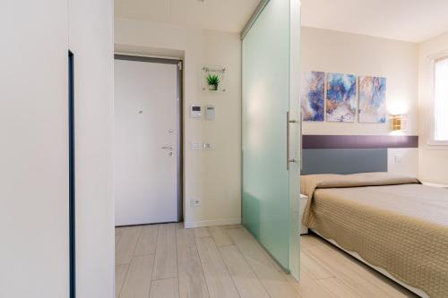a bedroom with a bed and a sliding glass door at Residenza Aloe in Boario Terme