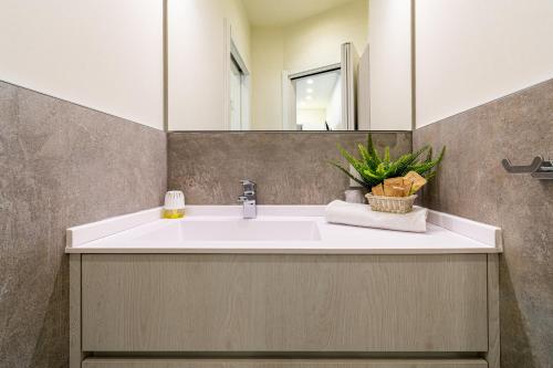 a bathroom with a white sink and a mirror at Residenza Aloe in Boario Terme
