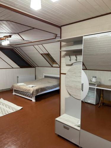 a bedroom with a bed and a desk in a room at Skarbivka in Vorokhta