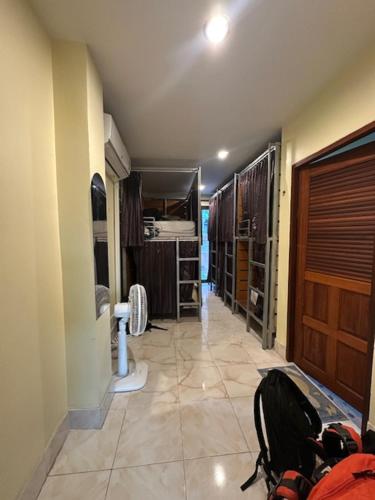a hallway of a room with a closet and a backpack at Tnon Samui Hostel in Chaweng