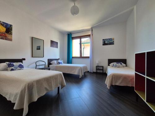 a hotel room with two beds and a window at Casa Scova, entire apartment in Garlasco