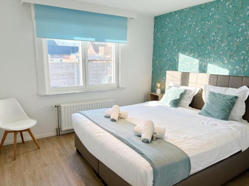 a bedroom with a large bed with two pillows on it at Villa Duin 33 in Westende