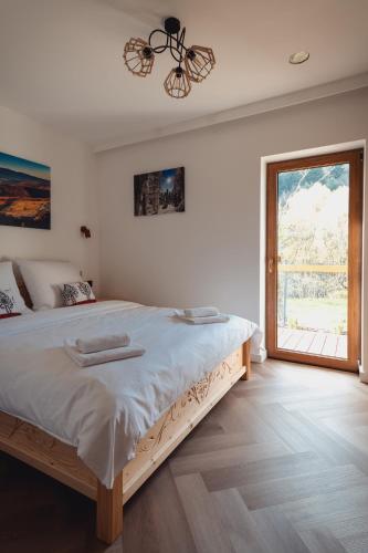 a bedroom with a large bed and a window at Muciówka in Jurków