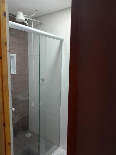 a shower with a glass door in a bathroom at EL Shaday in Guarujá