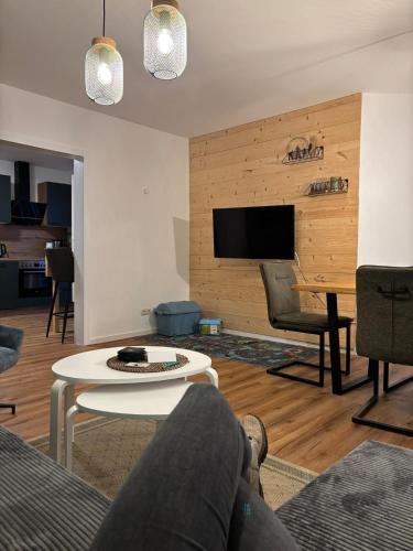 a living room with a couch and a table at Rathauswiese Ferienwohnung in Braunlage