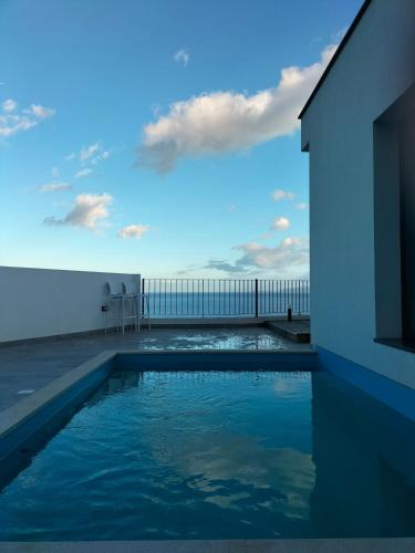 a swimming pool with a view of the ocean at Villa Atlantic Lodjadis in Gaula