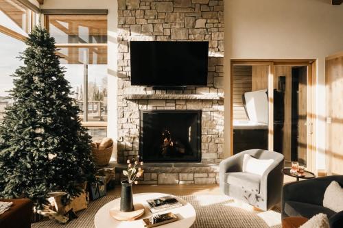 a living room with a christmas tree and a fireplace at The Lookout in Winter Park
