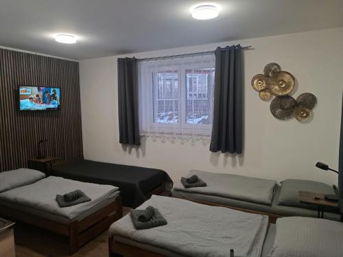 a living room with two beds and a couch at Ubytování AnDe in Třeboň