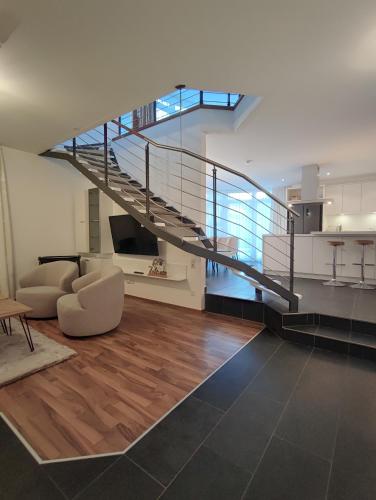 a living room with a spiral staircase in a house at das Alpenblick & Outdoor Lodge Nauders in Nauders