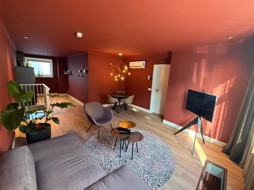 a living room with a couch and a tv at Fortuna Suites in Middelburg