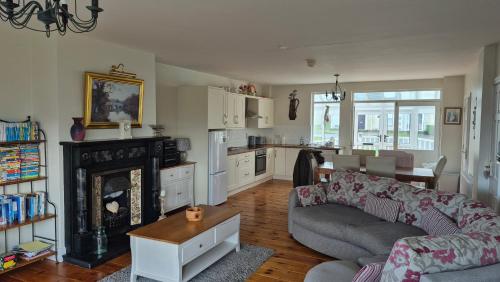 a living room with a couch and a fireplace at Fairway Haven in Dunfanaghy