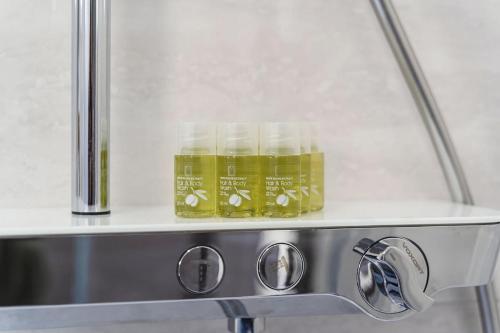 two jars of liquid sitting on top of a stove at 3-bedroom Sea View Home with Private Parking in Mokošica