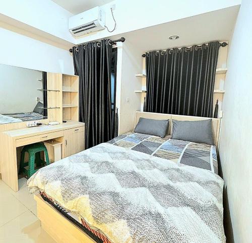 a bedroom with a bed and a dresser and a mirror at Narra Modern Living in Jakarta