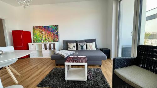 a living room with a couch and a table at Villa LaLeo in Künzelsau