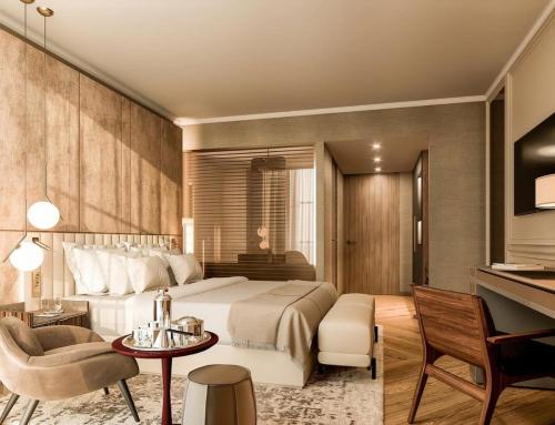 a hotel room with a large bed and a desk at Hotel Atlantiis Suites Near Kashi Vishwanath temple in Varanasi