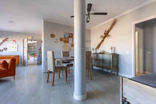 a dining room and living room with a table and chairs at MyRiverPlace River View Porto apartments in Vila Nova de Gaia
