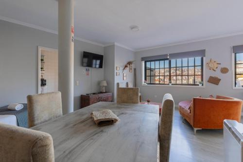 a dining room with a wooden table and chairs at MyRiverPlace River View Porto apartments in Vila Nova de Gaia