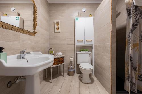 a bathroom with a sink and a toilet at MyRiverPlace River View Porto apartments in Vila Nova de Gaia