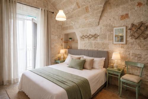 a bedroom with a large bed and a window at Dimora delle Badesse in Conversano