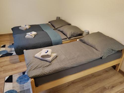 two twin beds in a room with towels on them at APARTMÁN KATKA Stošice - Liptovský Mikuláš, súkromue & pohodlie in Liptovský Mikuláš