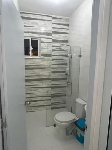 a bathroom with a toilet and a glass shower at Byk in Nagua