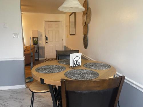 a dining room table with four chairs at Simply Home in Statesboro