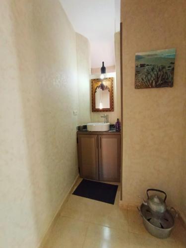 a bathroom with a sink and a mirror at Anar Surf House - Hostel & Private room's in Mirleft