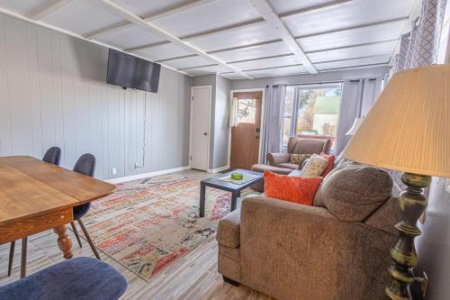 a living room with a couch and a table at Rustic 2 Bedroom Boho Apartment in Laramie