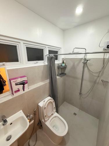 a bathroom with a toilet and a sink and a shower at Kaizen Urban Retreat - Elevate Your Stay in Calo