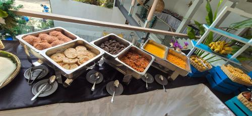 una tavola con diversi vassoi di cibo sopra di Brizo Paradiso a Matara
