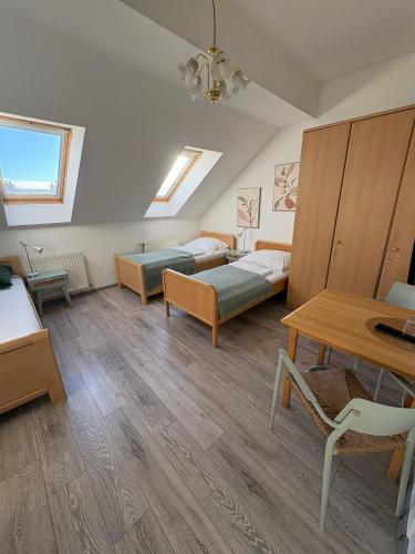 a living room with two beds and a table at Pension Lizzi in Vienna