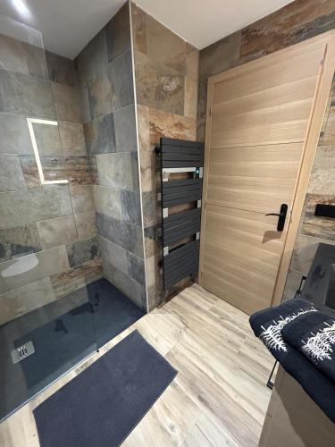 a bathroom with a shower and a door and a sink at Villa Casa Luma in Balaruc-les-Bains
