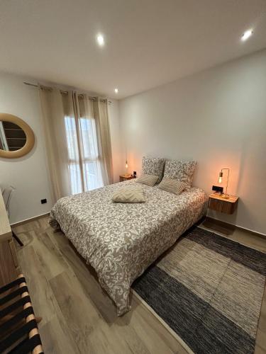 a bedroom with a bed and a large window at Villa Casa Luma in Balaruc-les-Bains