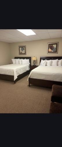 two beds in a large room with two beds sidx sidx sidx at Riverview Suites in Clarenville