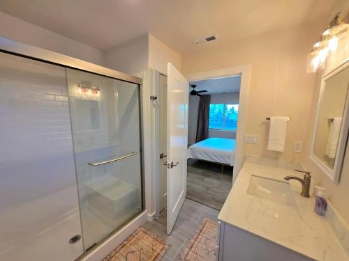 a bathroom with a shower and a glass shower backdoor at Lakefront Retreat • Private Yard + Fireplace in Clearlake Oaks