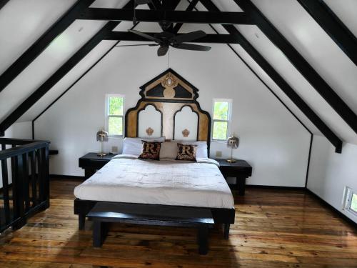 a bedroom with a large bed in a attic at Six Pillars Resort in Bastimentos