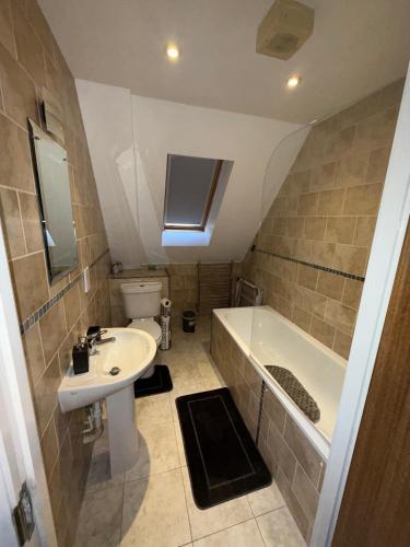 a bathroom with a sink and a bath tub at Guildford Court Apartment Colchester in Colchester