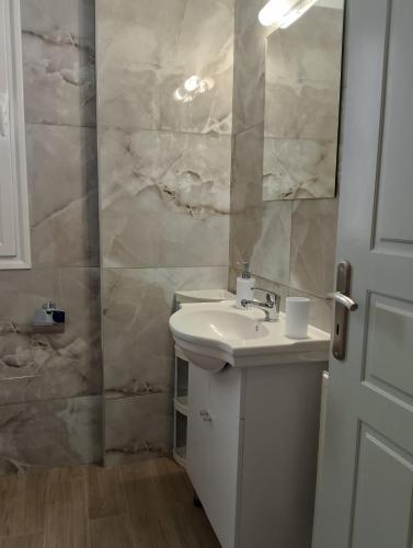 a white bathroom with a sink and a mirror at Villa Ioulia Malakonda, Eretria ,Greece in Eretria