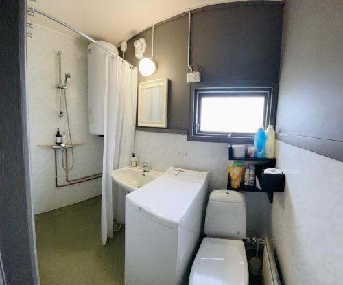 a small bathroom with a toilet and a sink at Nordnorge Self-Check-In in Majavatn