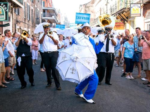 a group of men playing music in a street at Drop Your Bags In Your 2 Bdrm, 2 Full Bath Condo In French Quarters Prime Location in New Orleans