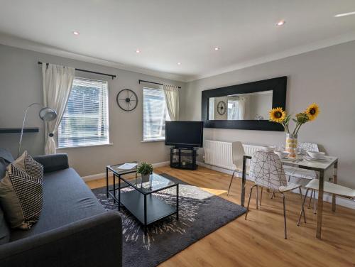 a living room with a couch and a table at Saffron Court Apartments in High Wycombe